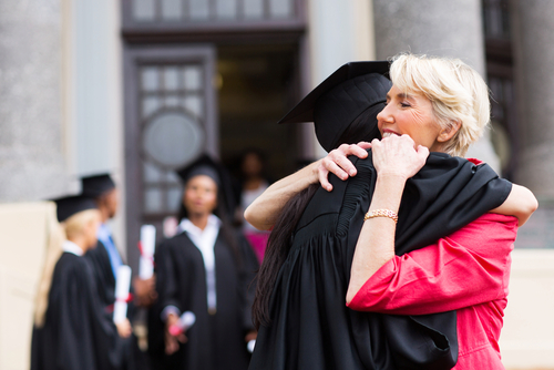 The Only Thing Certain in Life is Change. Photo of woman hugging someone at a graduation.